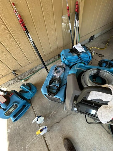 Professional restoration equipment arsenal including air movers and dehumidifiers